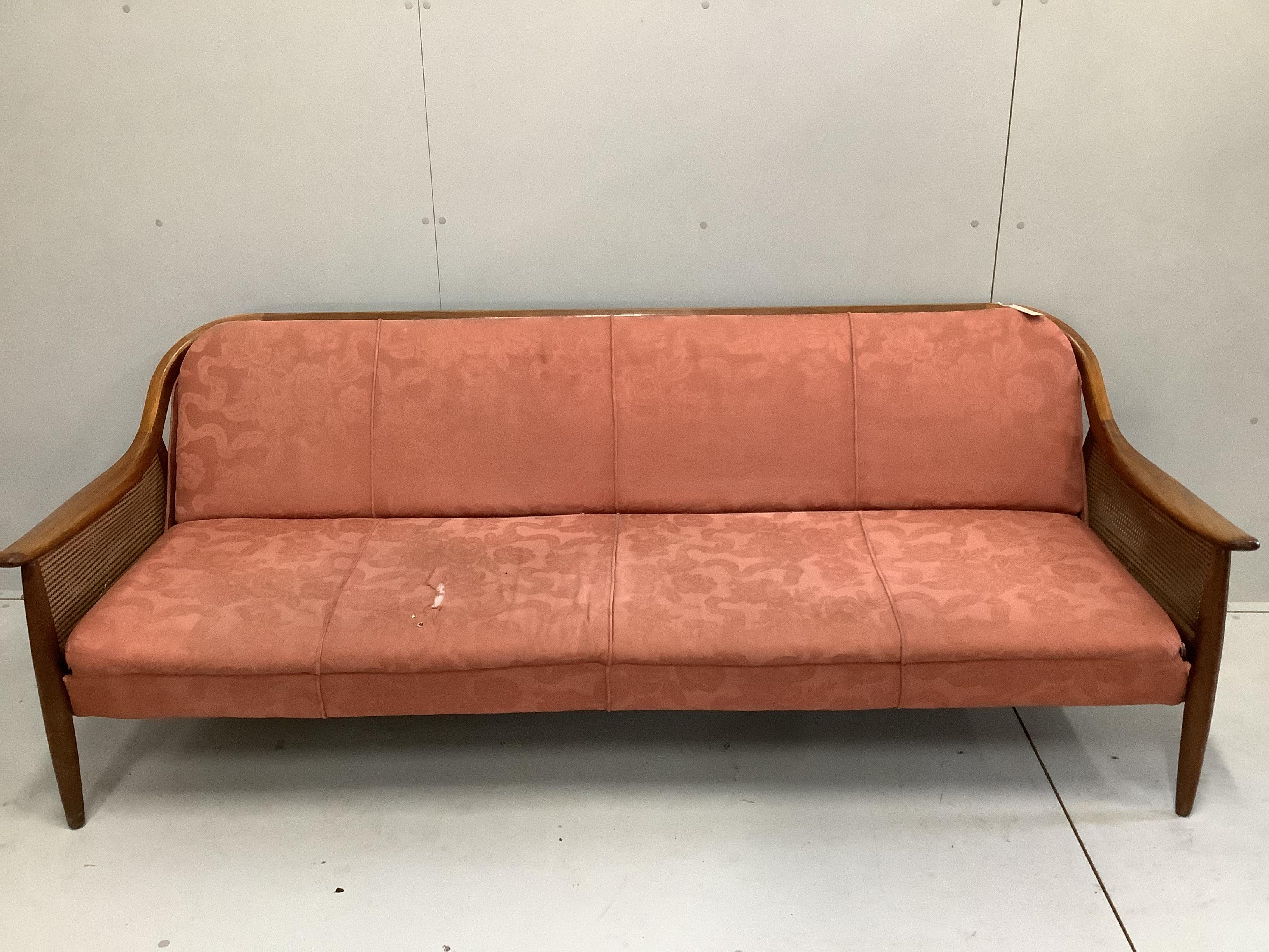 A mid century Danish design caned teak sofa bed, width 200cm, depth 75cm, height 75cm